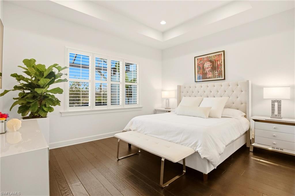 7157 Dominica Drive Naples, FL 34113 - Photo 20 of 39 a bedroom with a bed table and a window