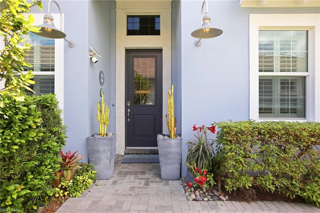 7157 Dominica Drive Naples, FL 34113 - Photo 2 of 39 a front view of a house with a backyard