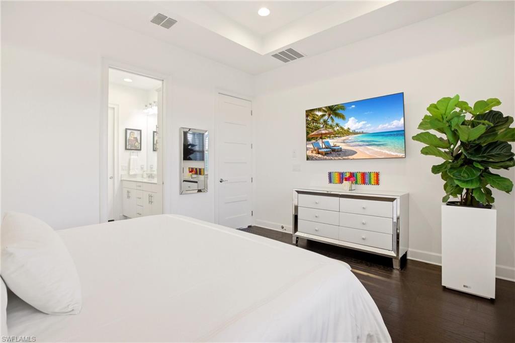 7157 Dominica Drive Naples, FL 34113 - Photo 21 of 39 a bedroom with a bed and a dresser