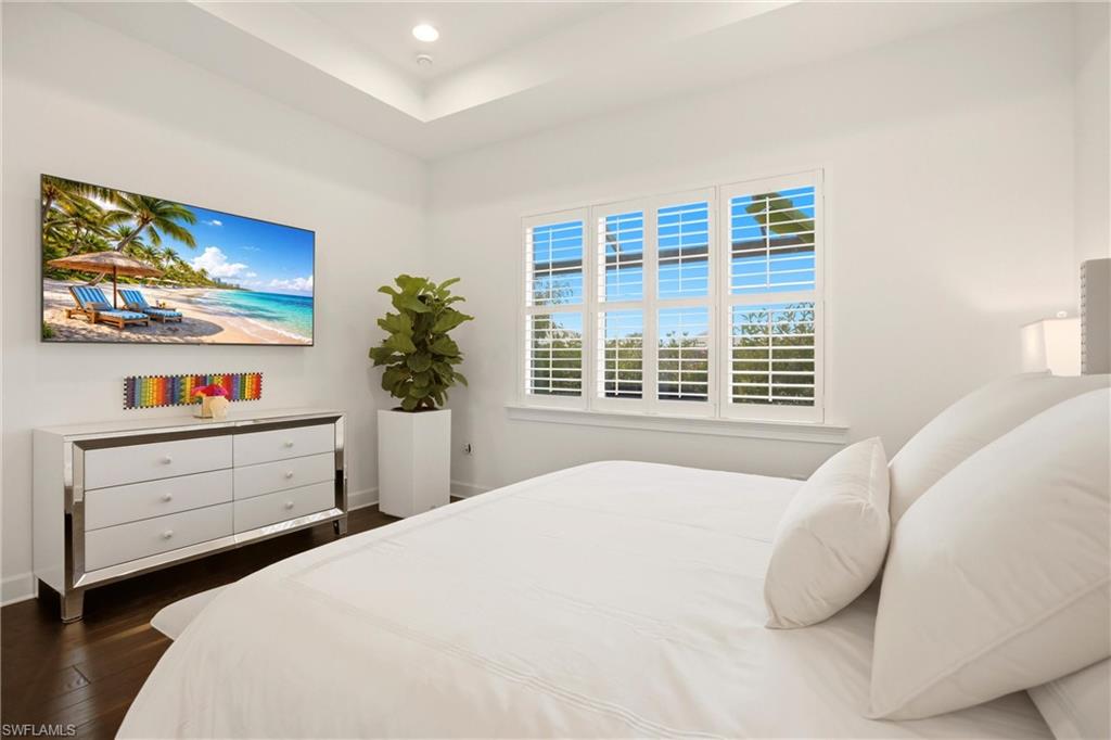 7157 Dominica Drive Naples, FL 34113 - Photo 22 of 39 a bedroom with a bed and a window