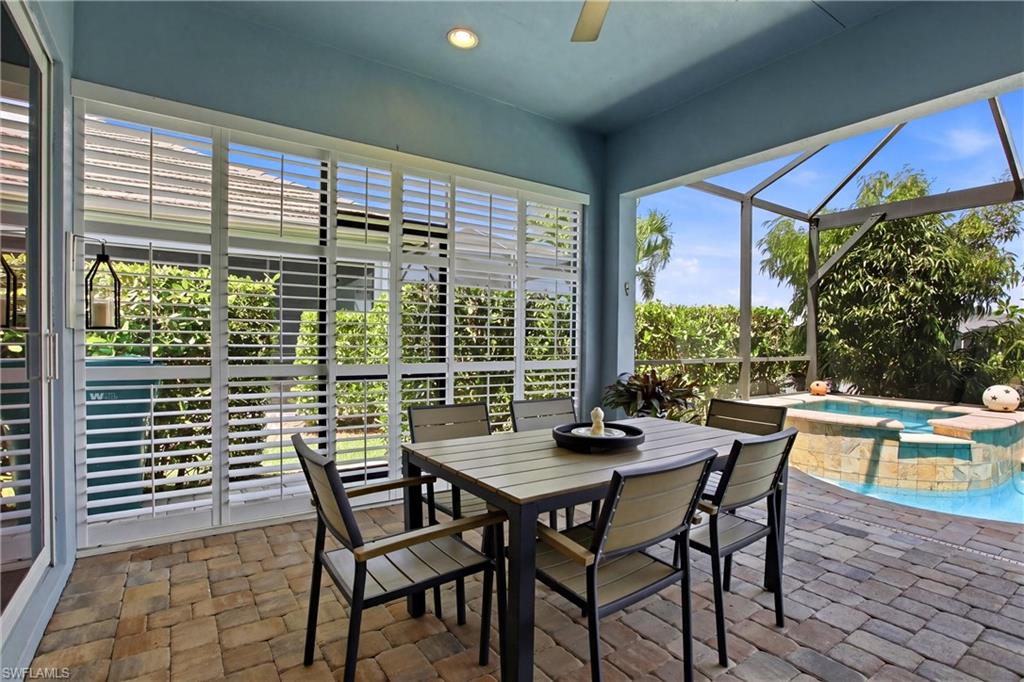 7157 Dominica Drive Naples, FL 34113 - Photo 29 of 39 a view of a dining room with furniture large windows and wooden floor