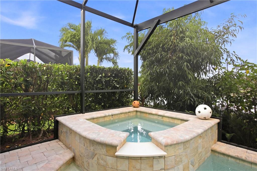 7157 Dominica Drive Naples, FL 34113 - Photo 33 of 39 a view of a swimming pool with a patio