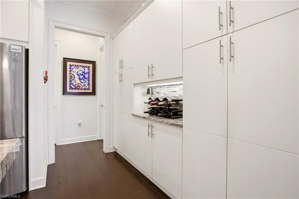 7157 Dominica Drive Naples, FL 34113 - Photo 10 of 39 a kitchen with stainless steel appliances a refrigerator and cabinets
