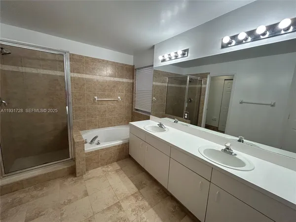 a white toilet sitting next to a shower