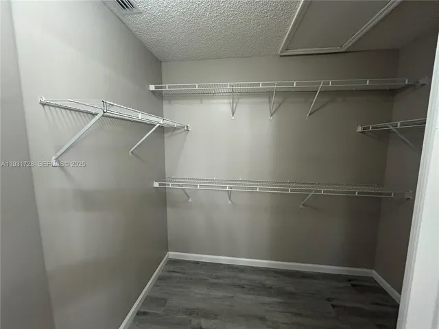 a kitchen with kitchen island granite countertop a stove and a sink