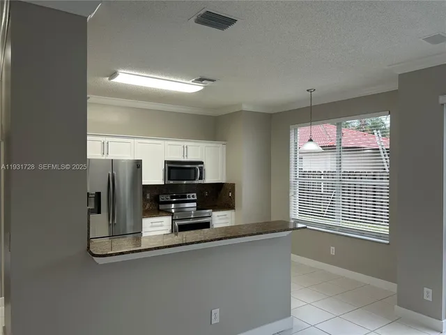 a bathroom with a glass door shower and a sink
