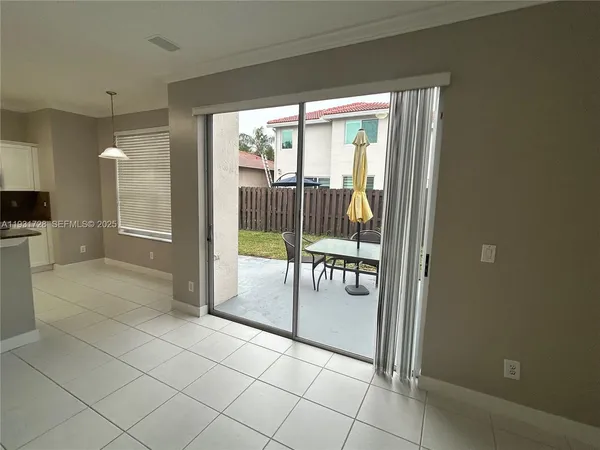 a view of kitchen with stainless steel appliances granite countertop a refrigerator and a sink