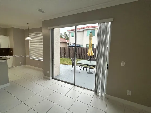 a view of kitchen with stainless steel appliances granite countertop a refrigerator and a sink
