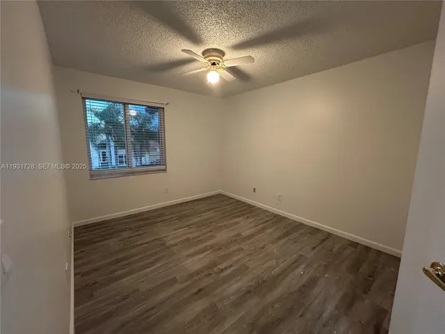 a bathroom with a granite countertop sink a mirror and shower