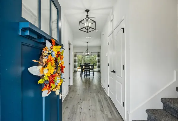 a view of a hallway with wooden floor and entryway