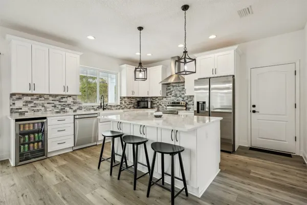 a kitchen with center island and windows