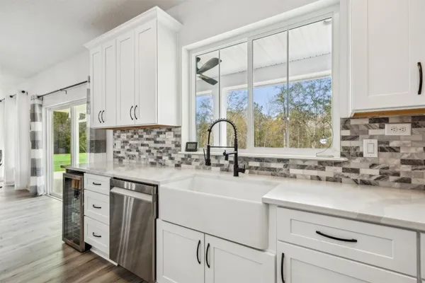 a kitchen with granite countertop white cabinets and white appliances