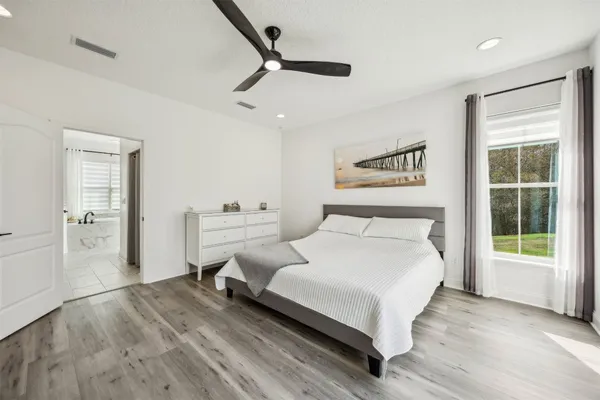 a bed sitting in a bedroom next to a window