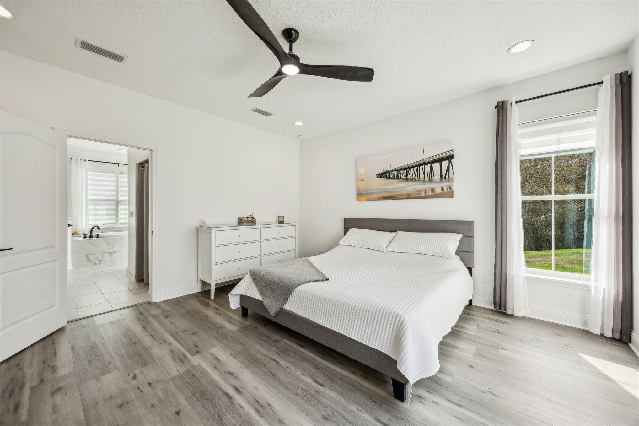 15466 Bullock Bluff Road Bryceville, FL 32009 - Photo 24 of 54 a spacious bedroom with a bed and a window