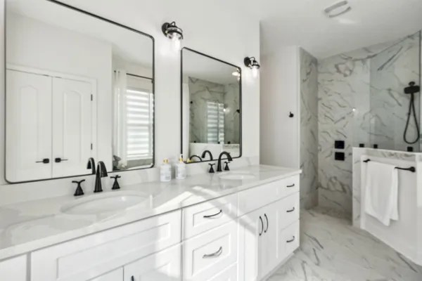 a bathroom with a tub a sink and a window