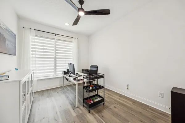 a view of a workspace with furniture and a window
