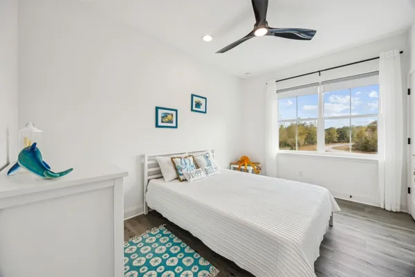 a bedroom with a bed and window