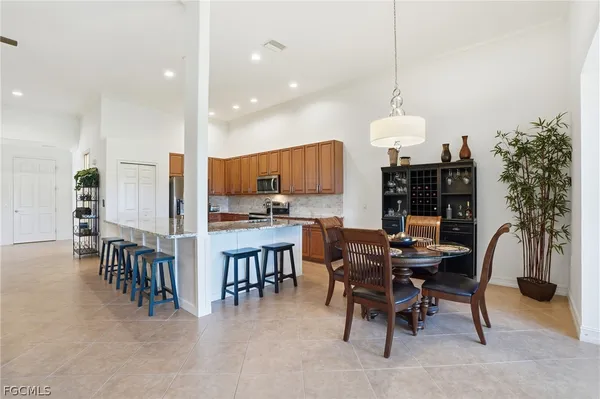 a large kitchen with a table and chairs