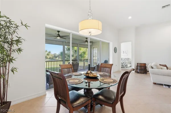 a view of a dining room with furniture wooden floor and chandelier
