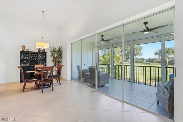 a dining room with furniture water view and a floor to ceiling window