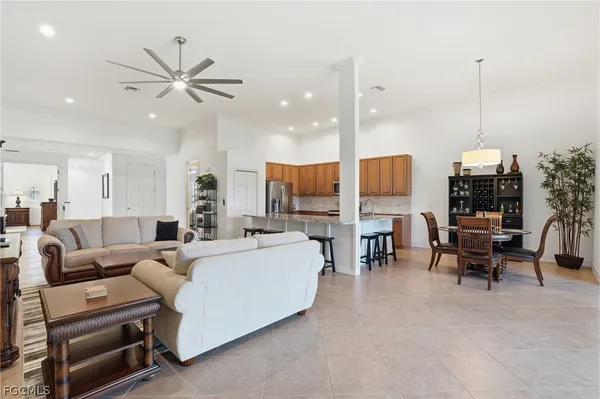a living room with furniture and a floor to ceiling window