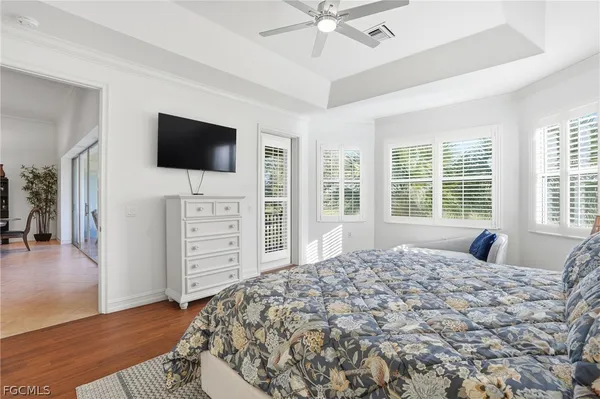 a large bedroom with a bed and a flat screen tv