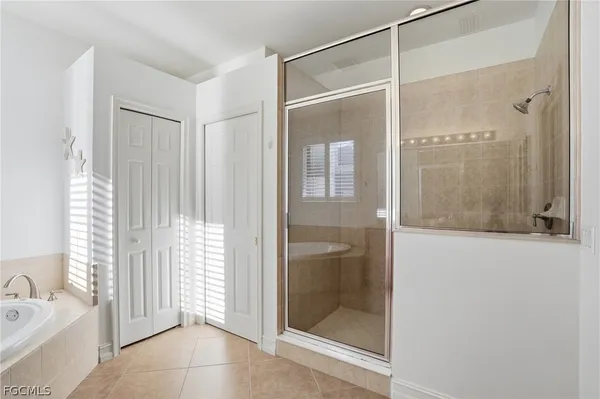 a bathroom with a glass shower door and a bathtub