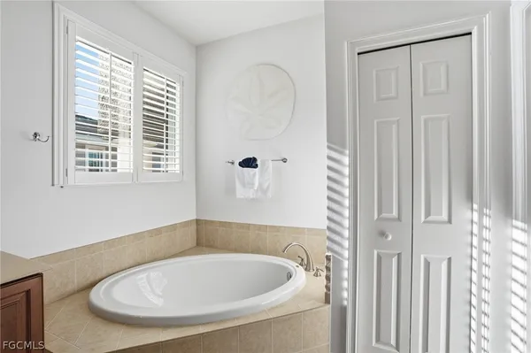 a bathroom with a tub and a window