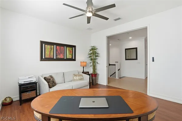 a living room with furniture and wooden floor