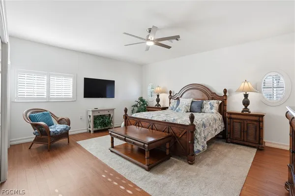 a spacious bedroom with a bed and a chair