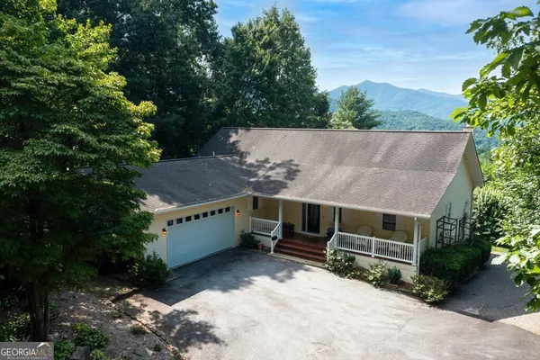 an aerial view of a house with a yard