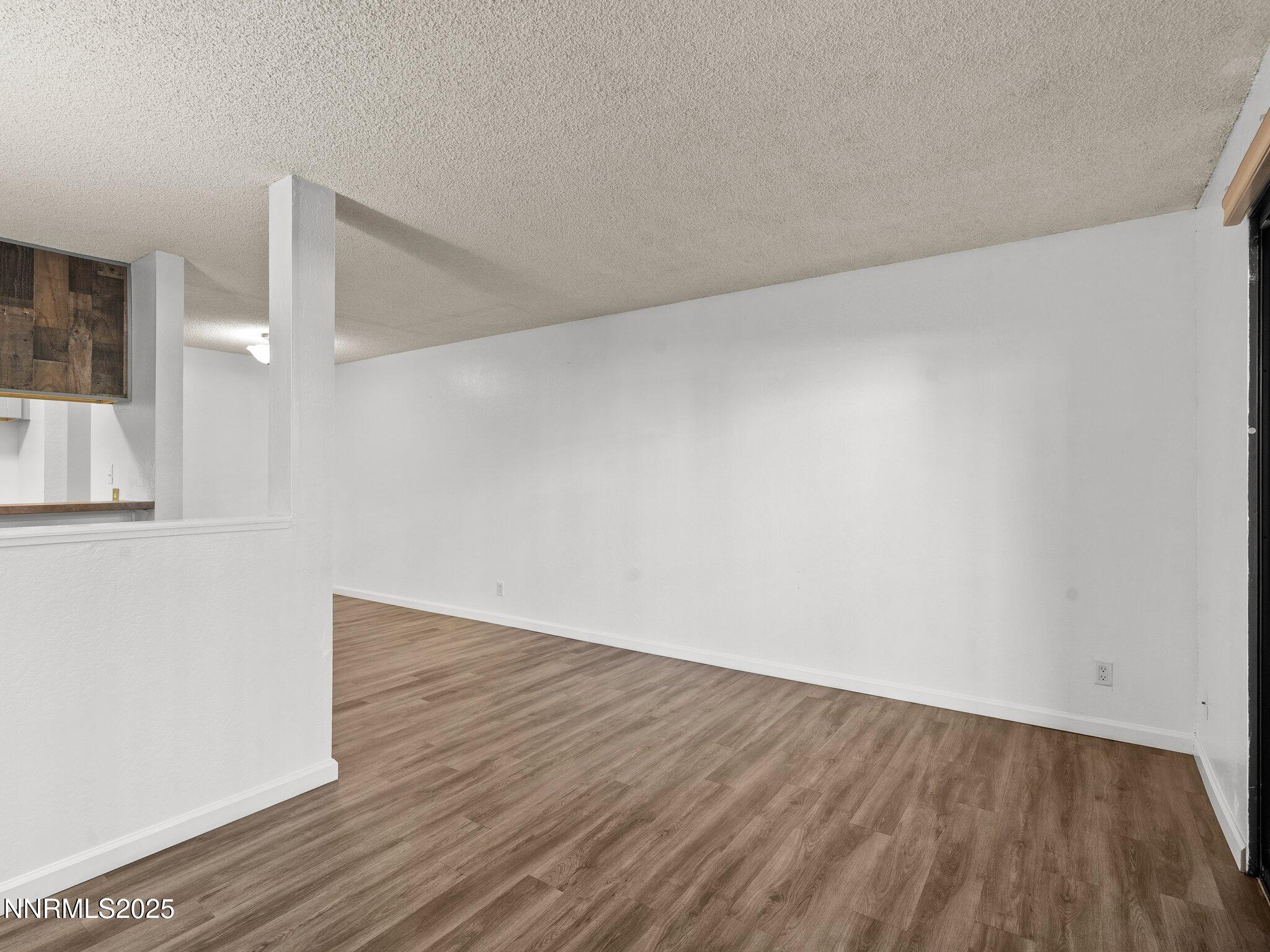 2955 Lakeside Drive, Unit 111 Reno, NV 89509 - Photo 15 of 45 a view of an empty room with wooden floor and a window