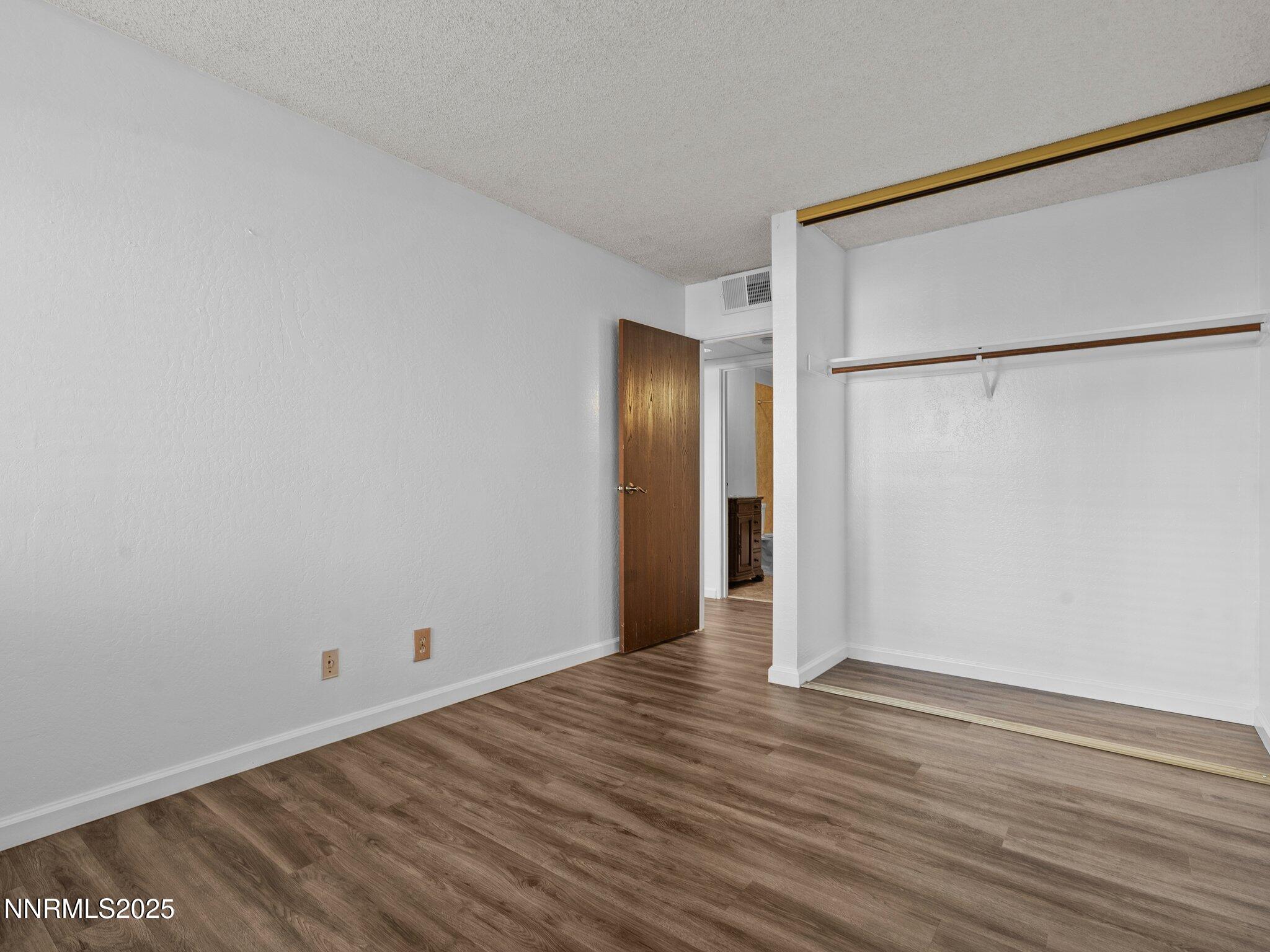 2955 Lakeside Drive, Unit 111 Reno, NV 89509 - Photo 20 of 45 a view of an empty room with wooden floor and a window