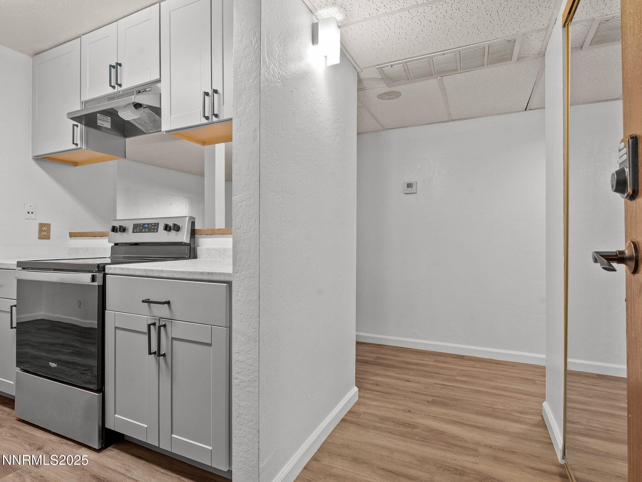 2955 Lakeside Drive, Unit 111 Reno, NV 89509 - Photo 2 of 45 a view of a kitchen with closet and wooden floor