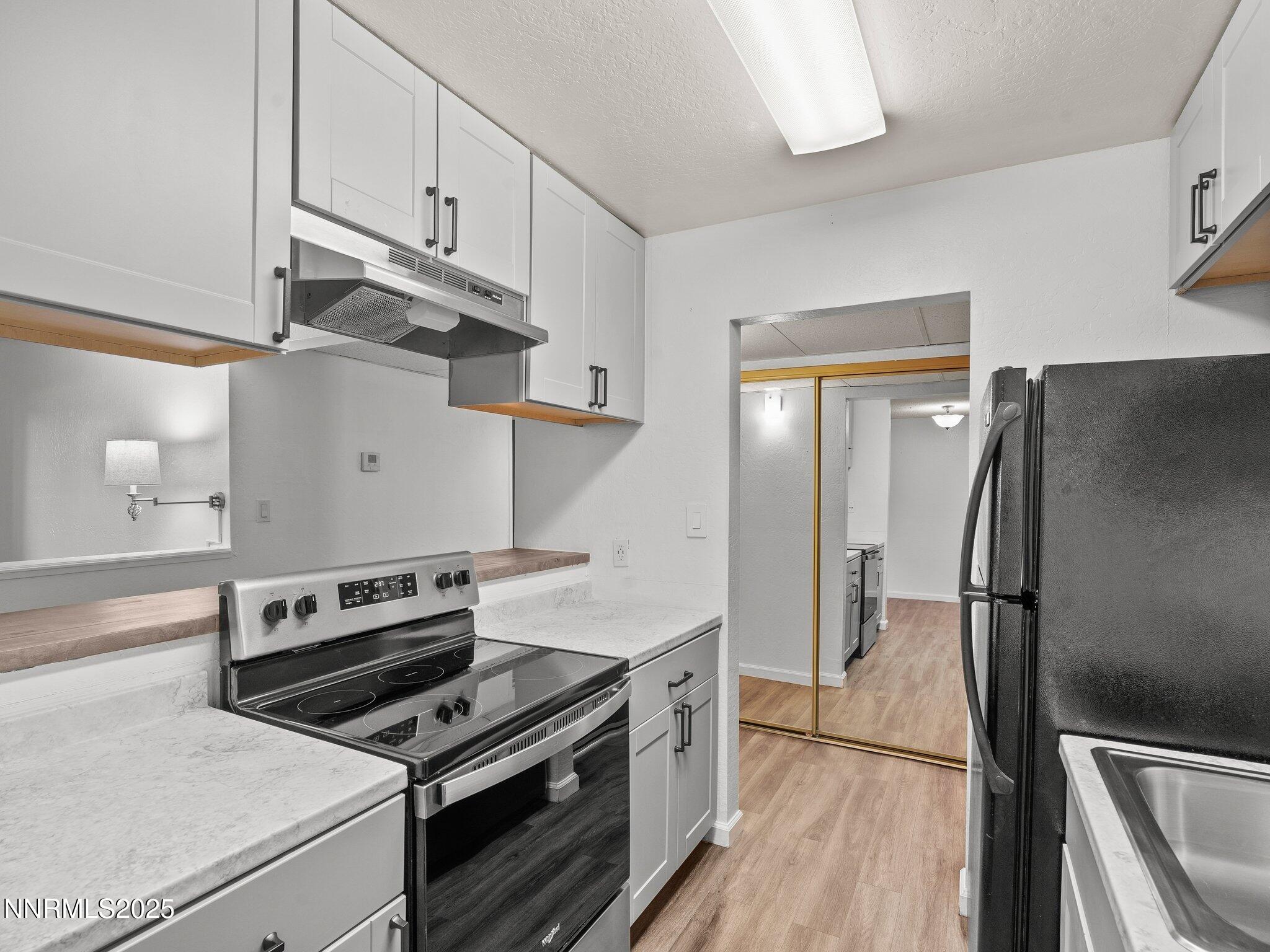 2955 Lakeside Drive, Unit 111 Reno, NV 89509 - Photo 5 of 45 a kitchen with cabinets and steel stainless steel appliances