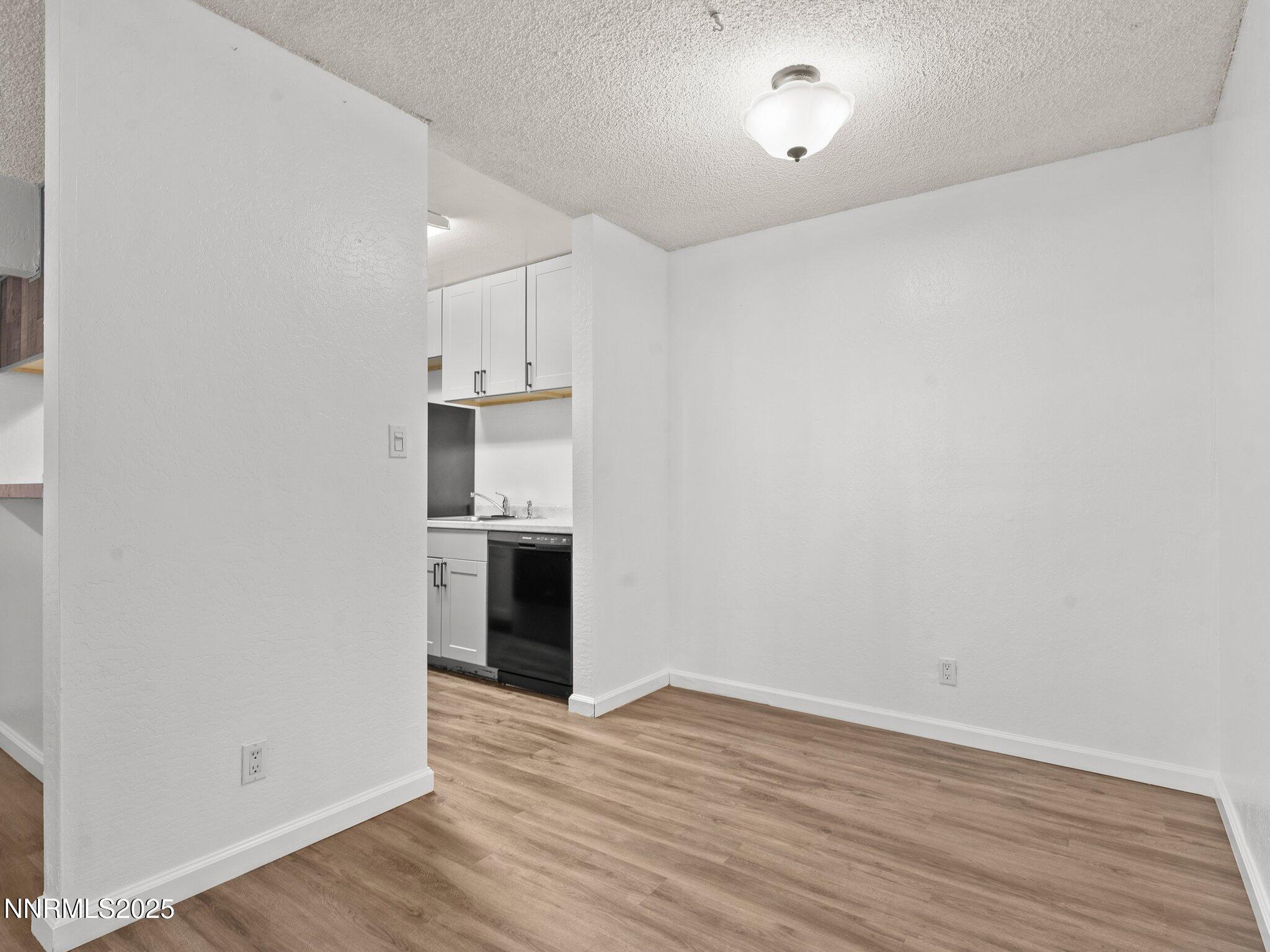 2955 Lakeside Drive, Unit 111 Reno, NV 89509 - Photo 9 of 45 wooden floor in an empty room with a kitchen