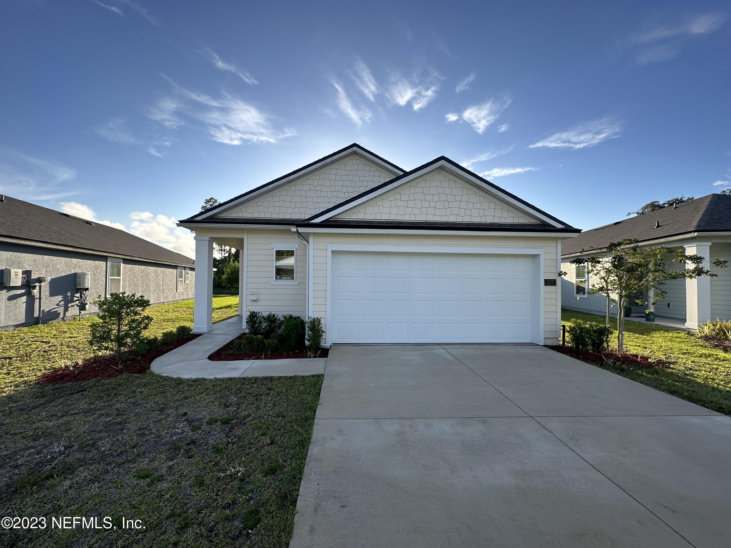 a front view of a house with garden
