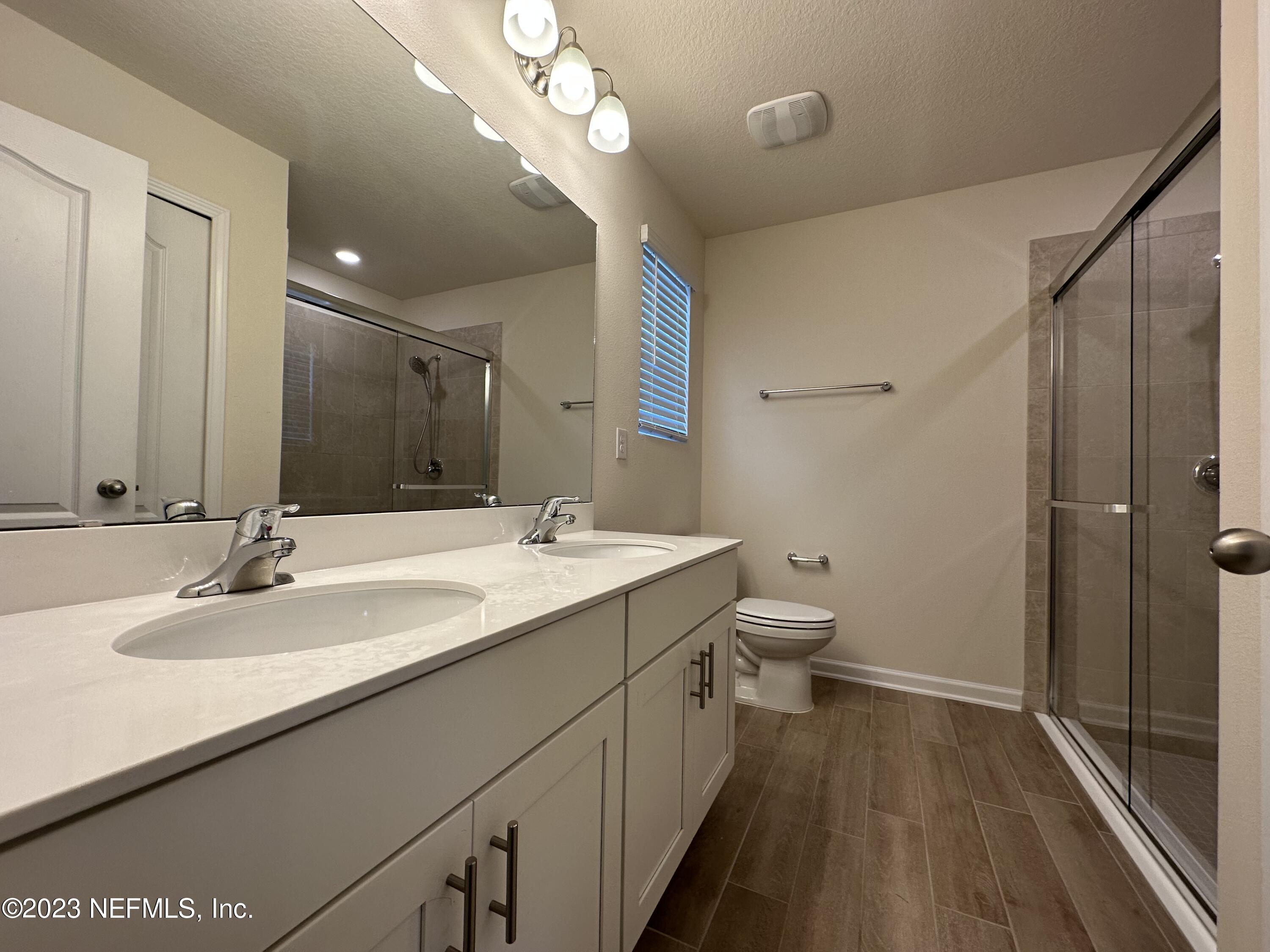 137 Chasewood Drive St. Augustine, FL 32095 - Photo 13 of 29 a bathroom with a double vanity sink and a mirror