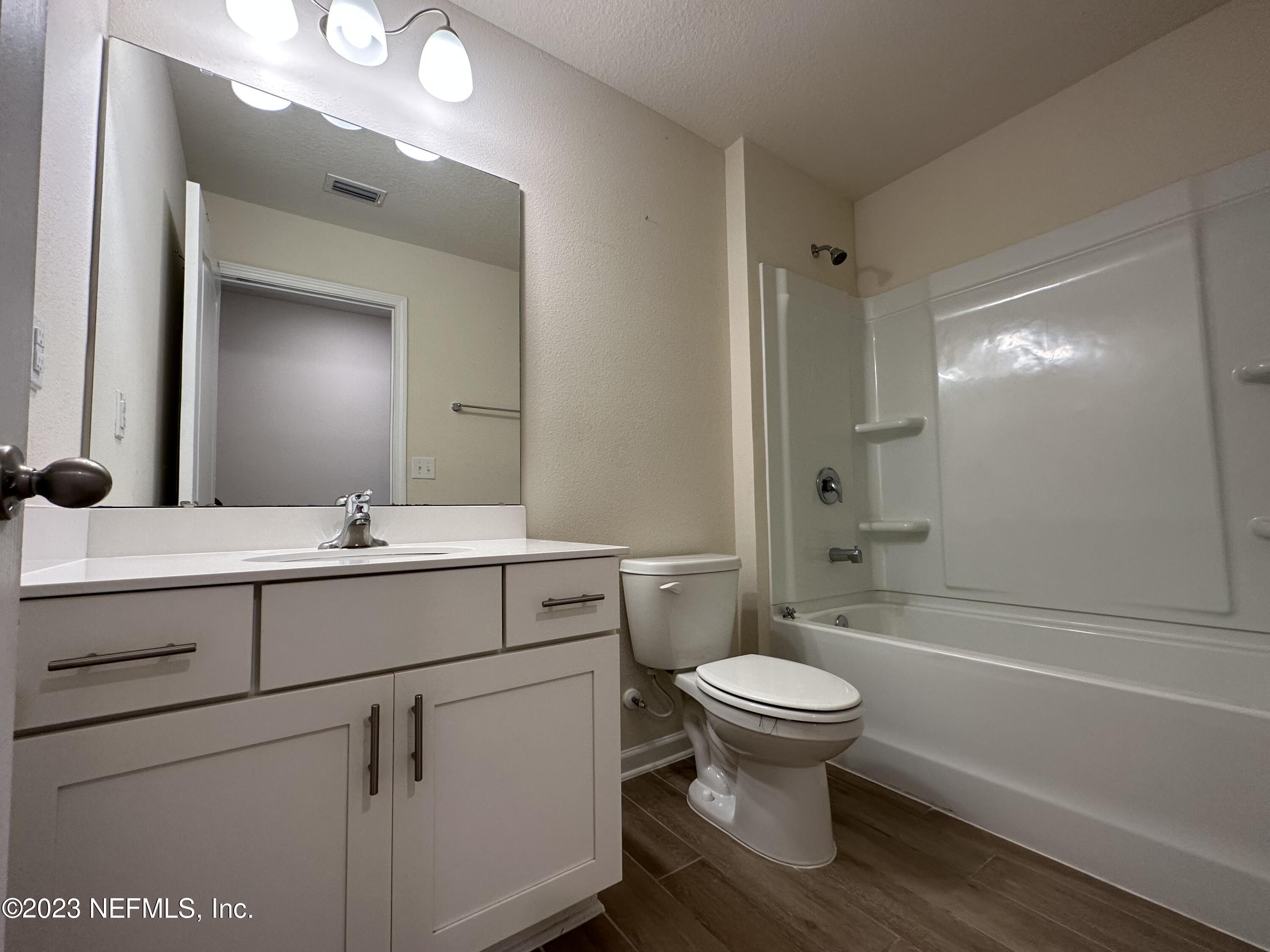 137 Chasewood Drive St. Augustine, FL 32095 - Photo 19 of 29 a bathroom with a sink toilet vanity and shower