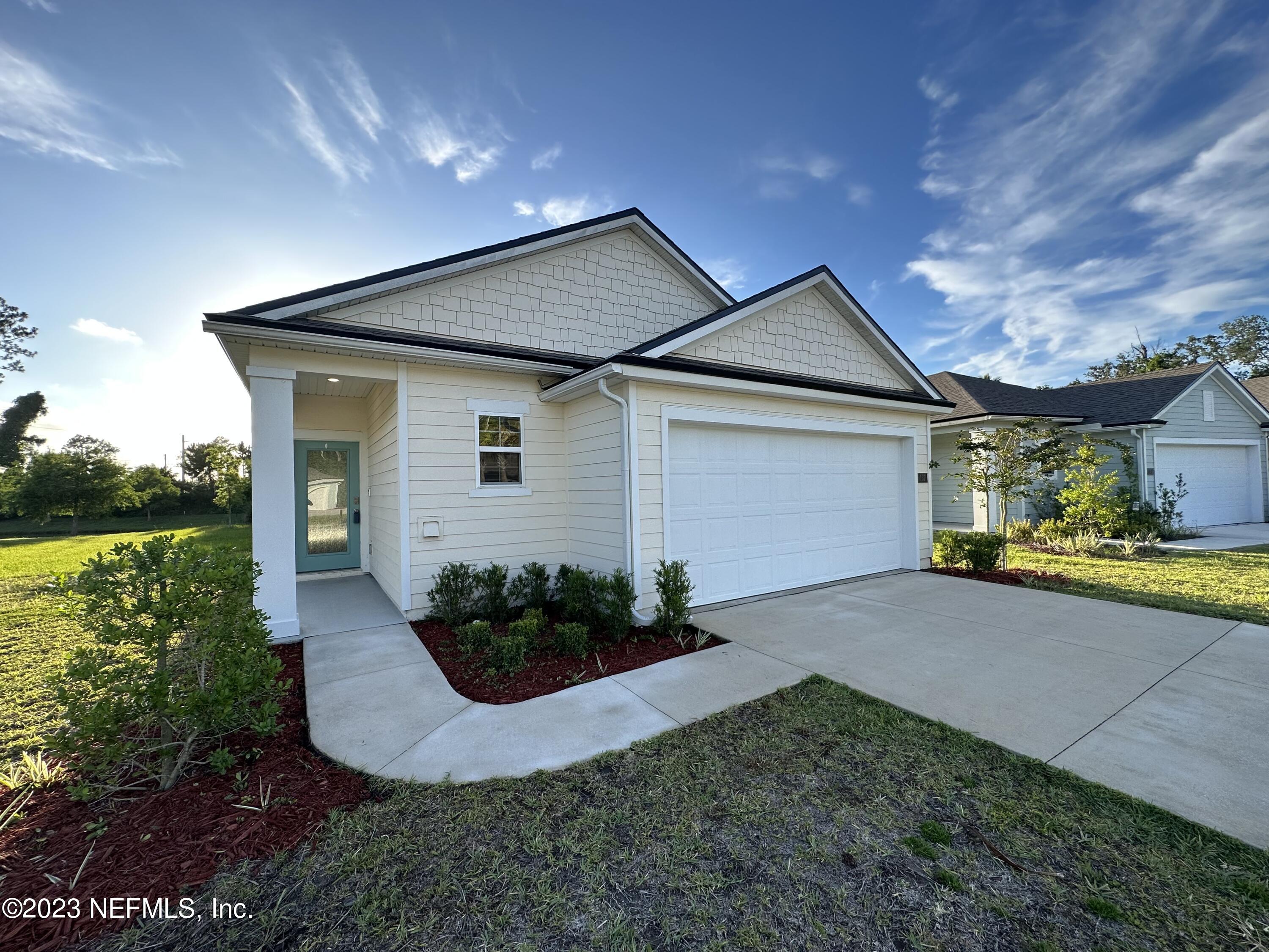 137 Chasewood Drive St. Augustine, FL 32095 - Photo 2 of 29 a view of a house with backyard and garden