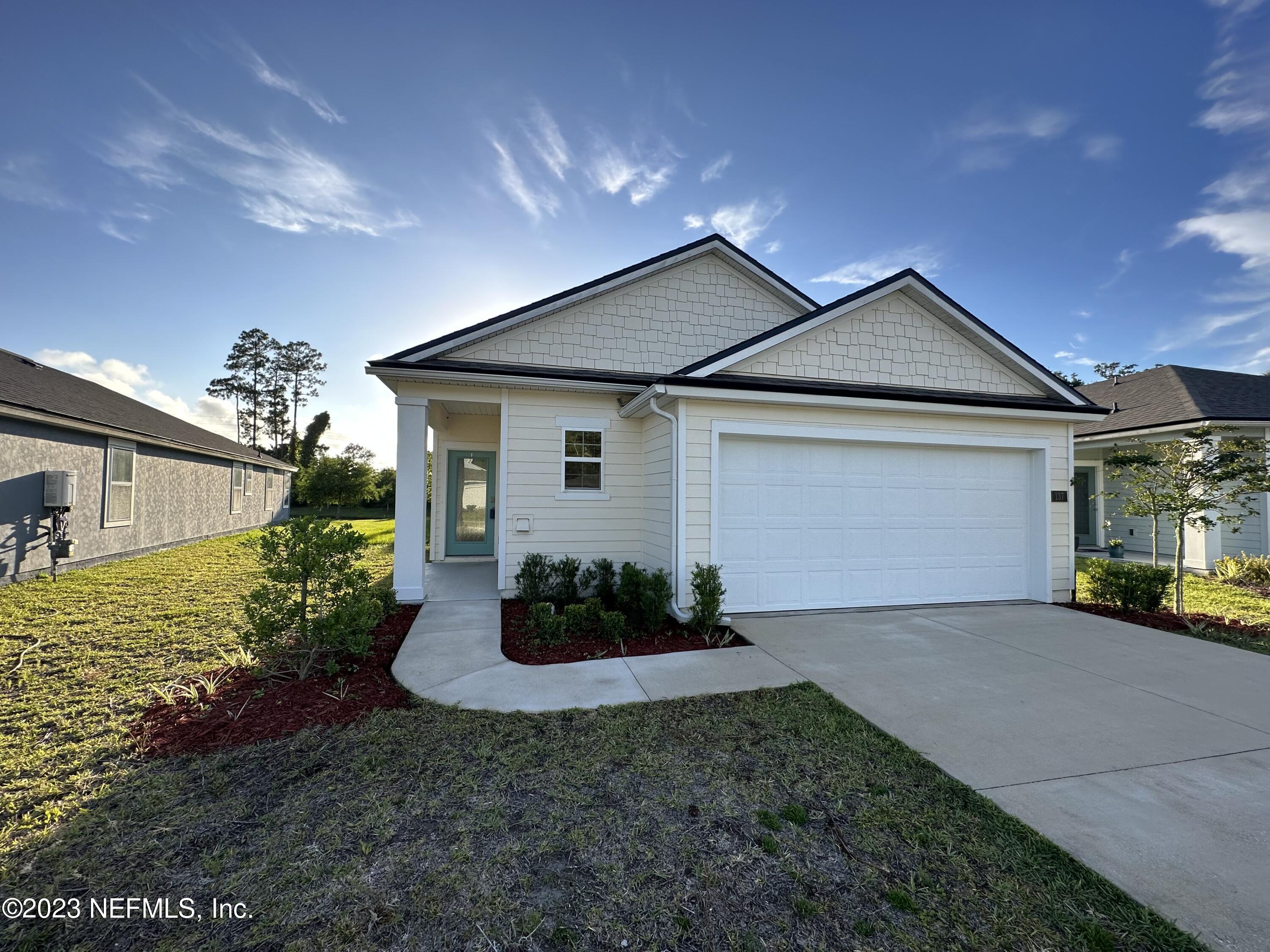 137 Chasewood Drive St. Augustine, FL 32095 - Photo 3 of 29 a front view of a house with garden