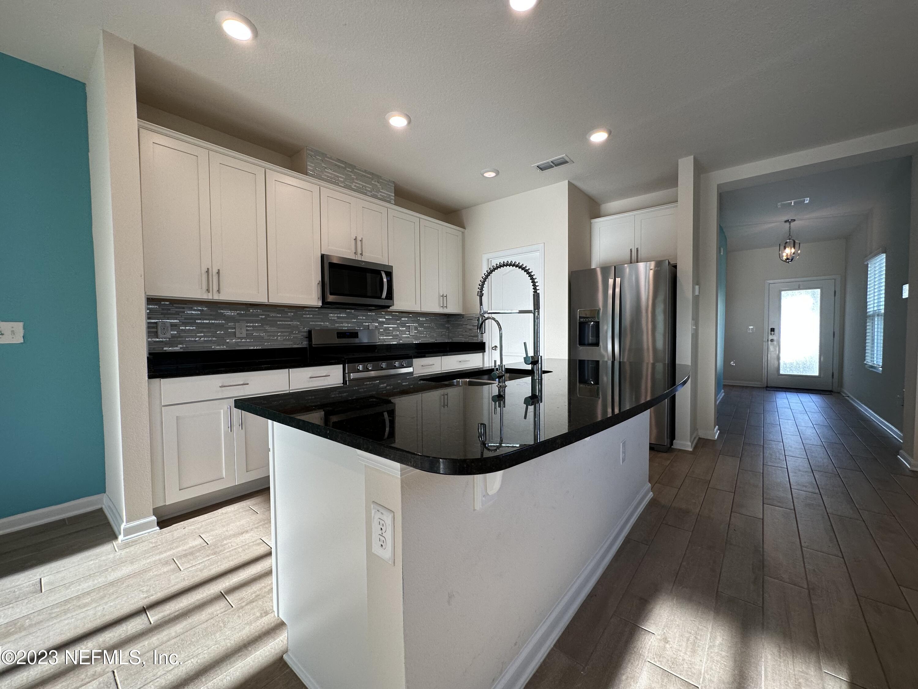 137 Chasewood Drive St. Augustine, FL 32095 - Photo 5 of 29 a kitchen with stainless steel appliances granite countertop a sink a stove and a refrigerator