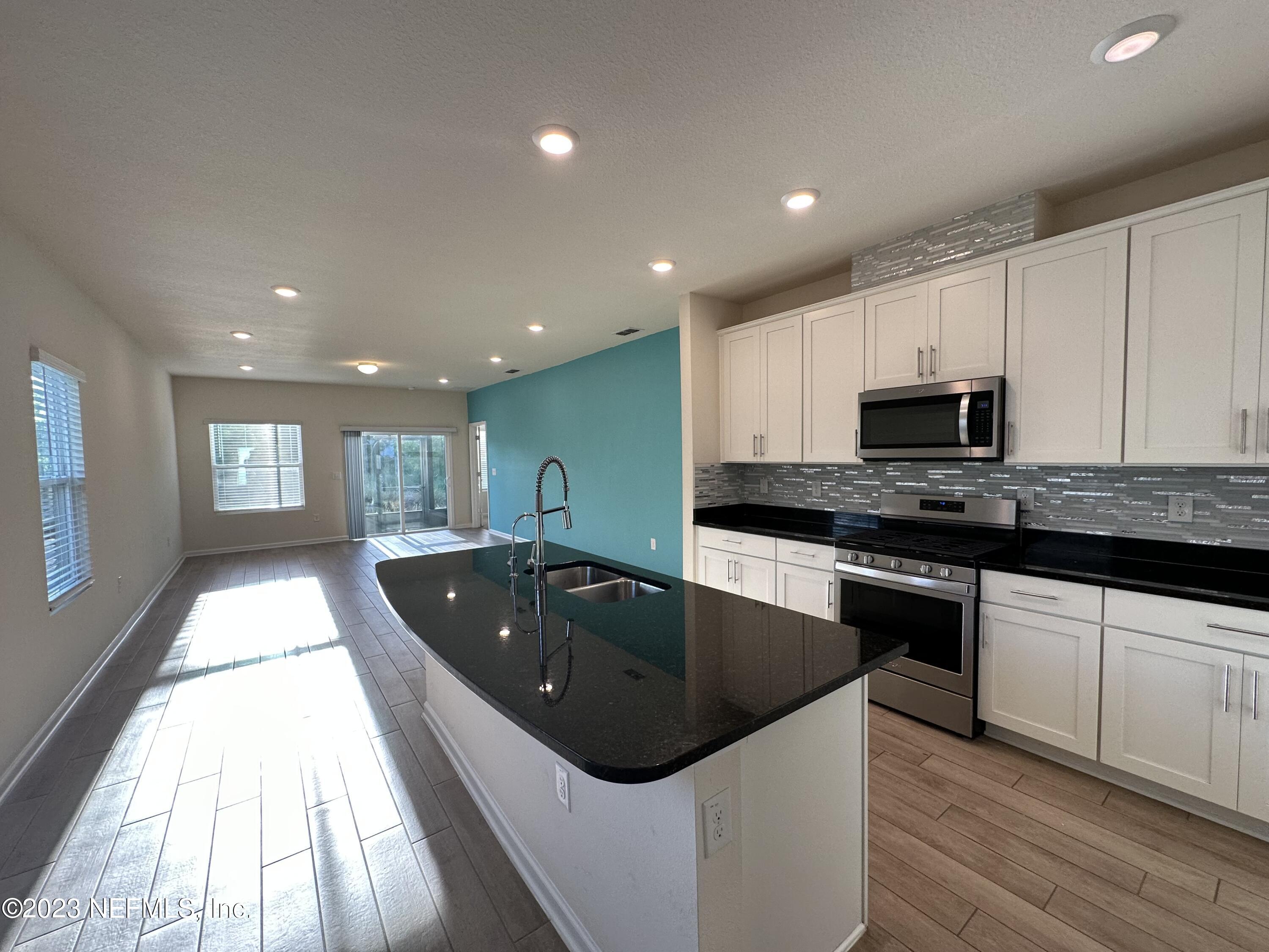 137 Chasewood Drive St. Augustine, FL 32095 - Photo 6 of 29 a kitchen with kitchen island granite countertop a sink and stainless steel appliances