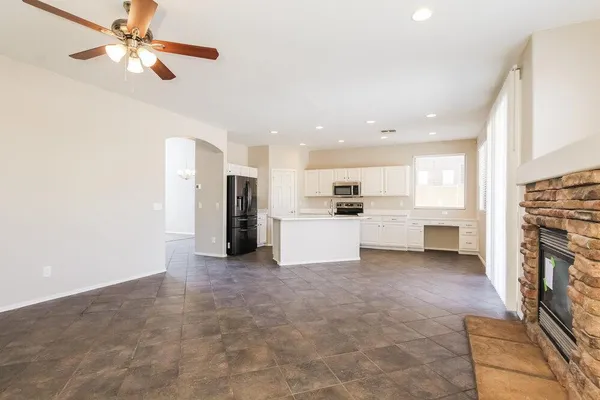 a view of a kitchen with a stove cabinets and a ceiling fan