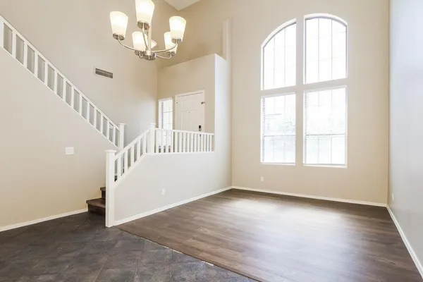 wooden floor in an empty room with a window