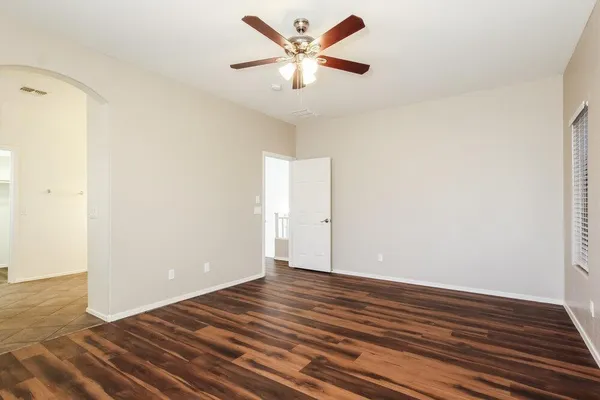 a view of an empty room with wooden floor
