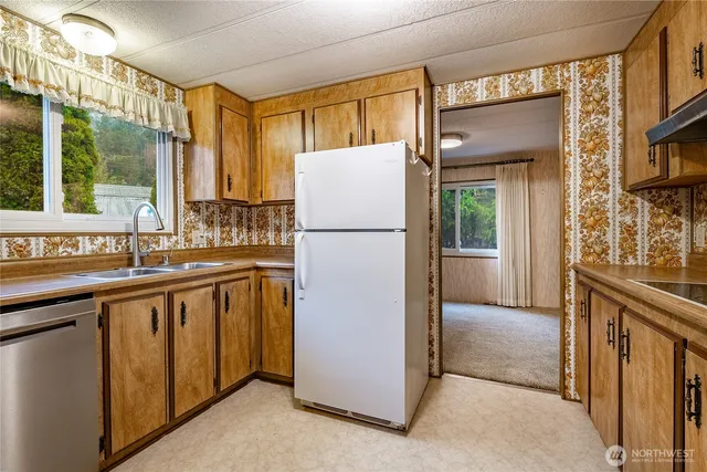 a kitchen with a refrigerator and a sink