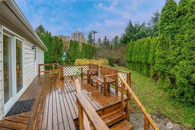 a view of a patio with chairs next to a yard