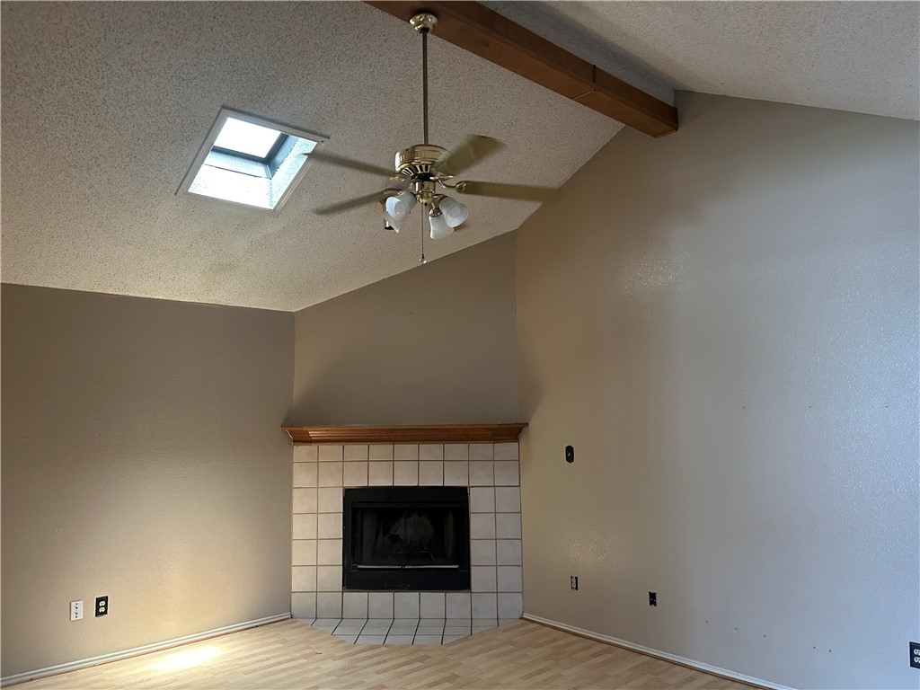 4530 Windows Drive Corpus Christi, TX 78413 - Photo 2 of 11 an empty room with chandelier fan and fireplace