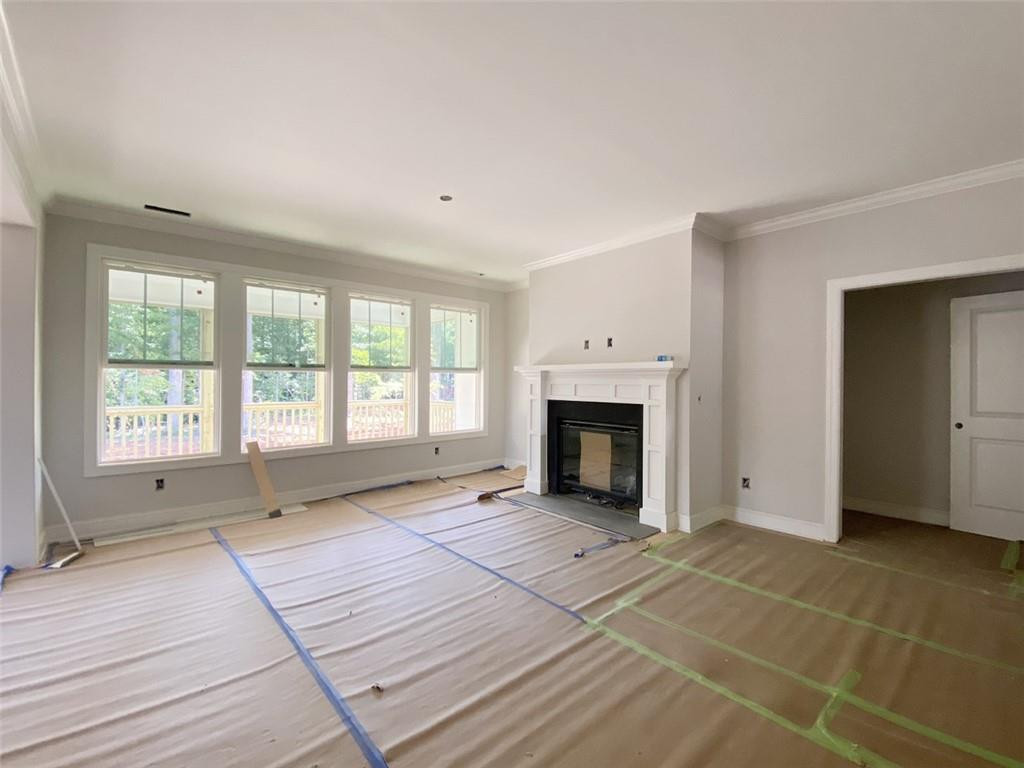 7584 Cypress Drive Graham, NC 27253 - Photo 3 of 18 a view of an empty room with a fireplace and a window